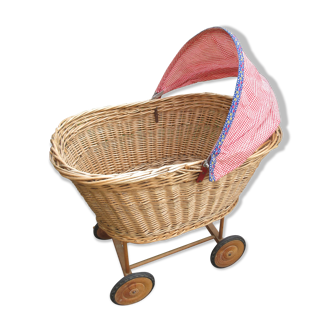 Doll cradle on wicker wheels