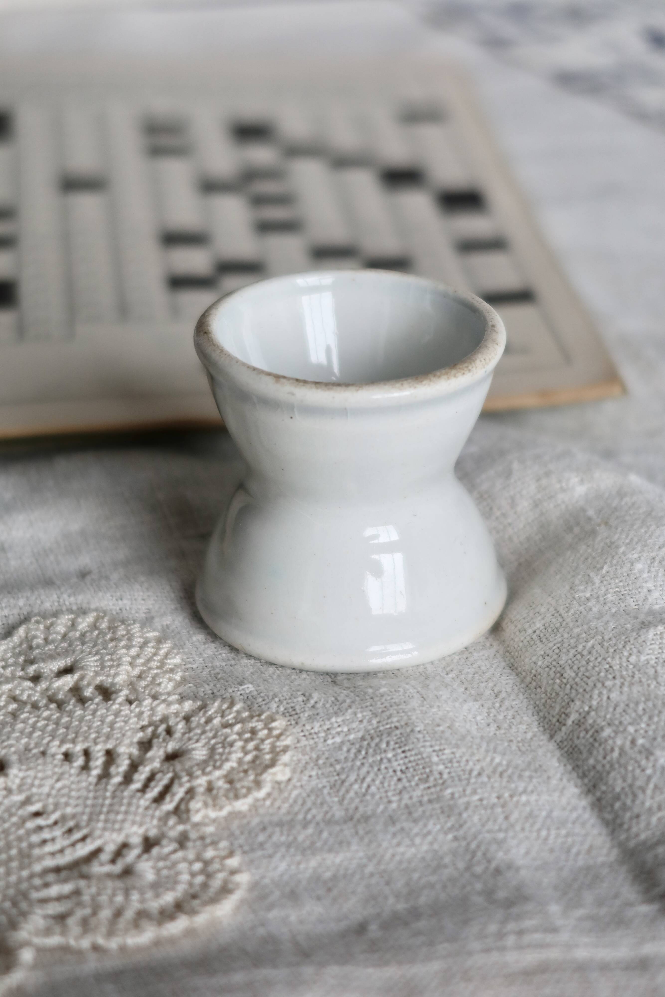 Antique diabolo egg cup in white earthenware