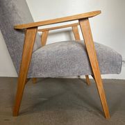 Vintage armchair reupholstered in light grey.