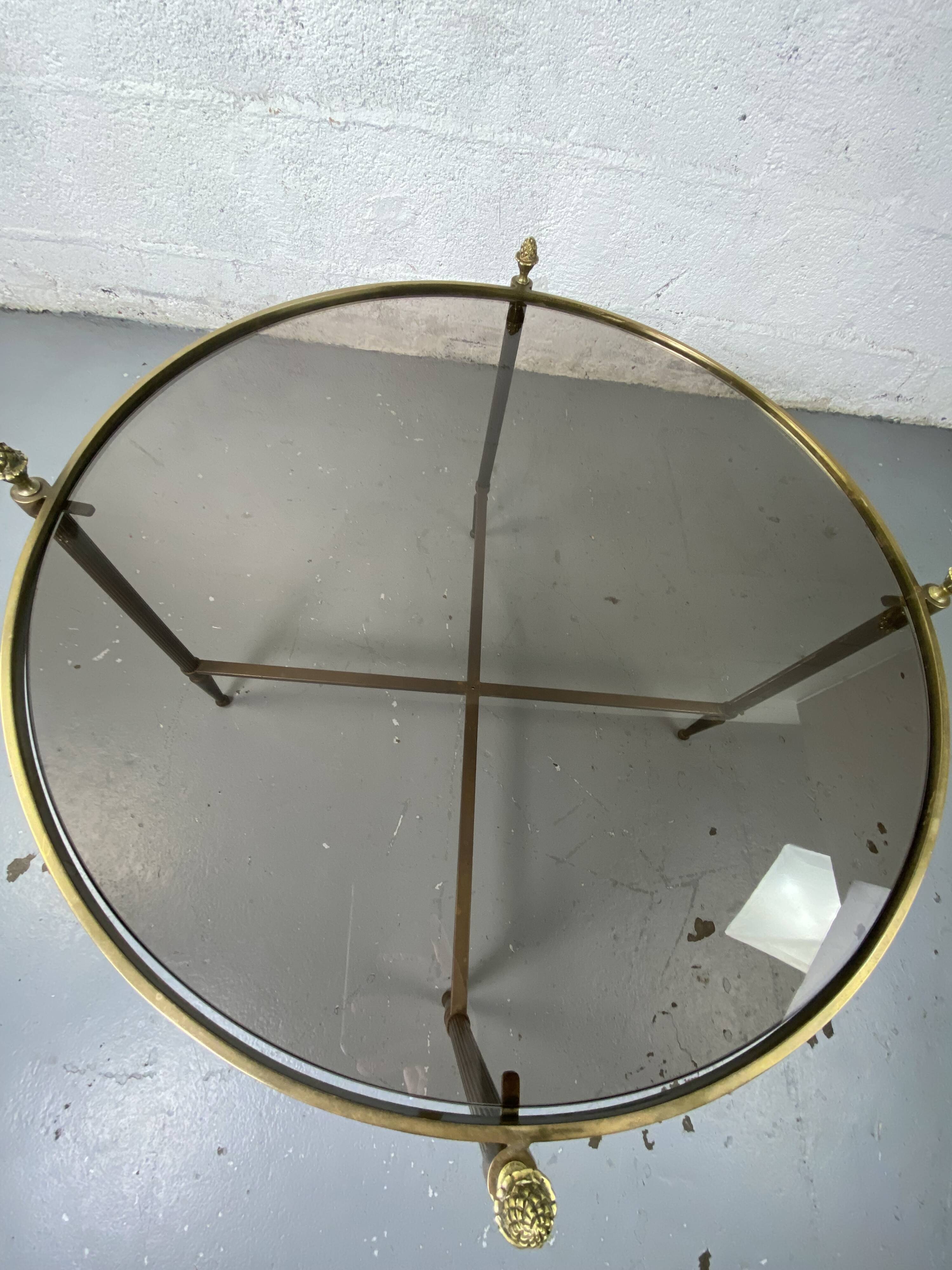 Round coffee table in brass and smoked glass