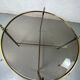 Round coffee table in brass and smoked glass