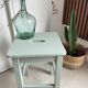 Antique almond green wooden stool