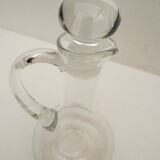 small glass decanter with its handle and spout