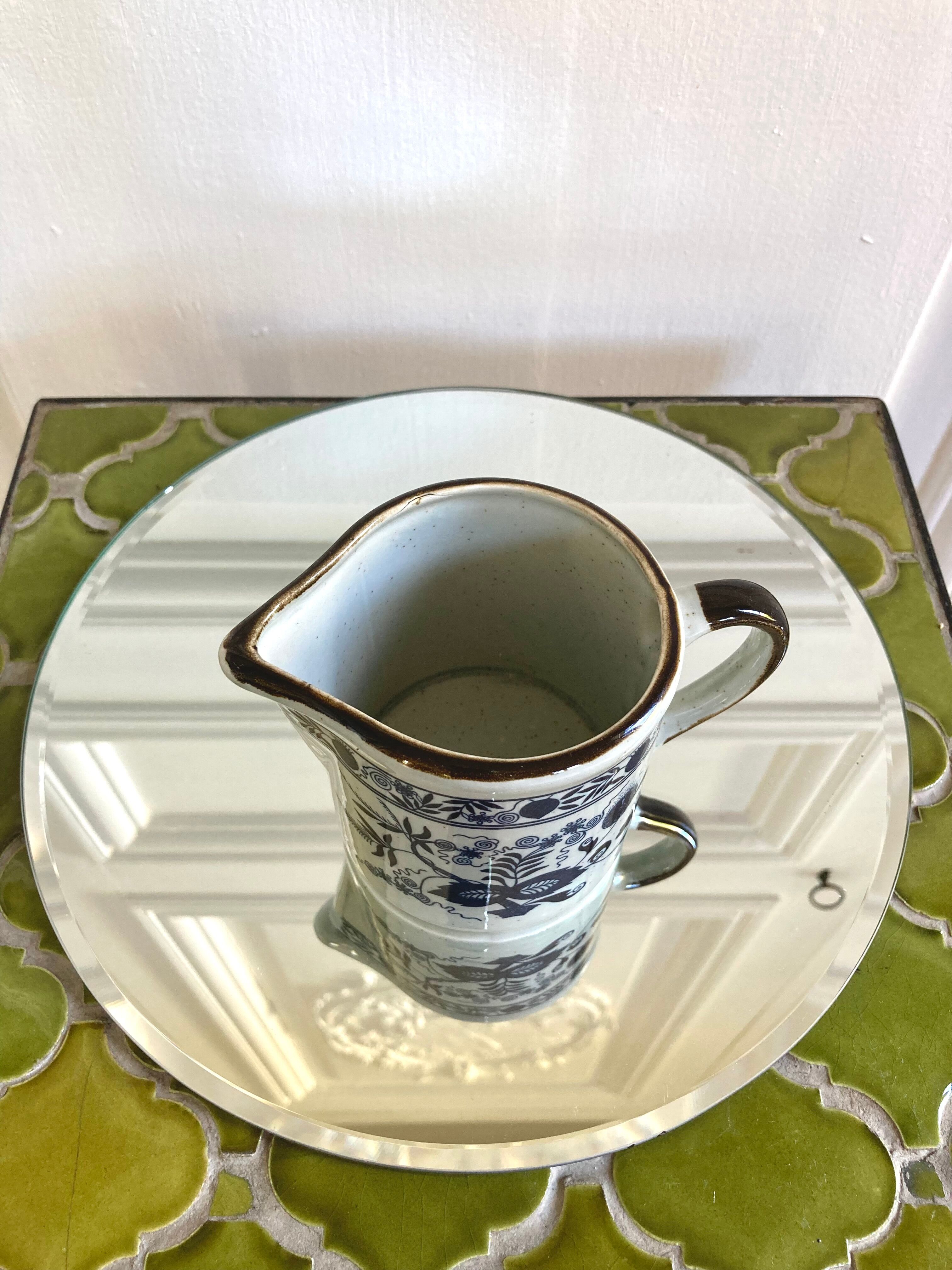 Stoneware milk jug with flower decoration