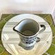 Stoneware milk jug with flower decoration