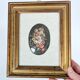 Vintage floral print with oval mat and gold wooden frame.