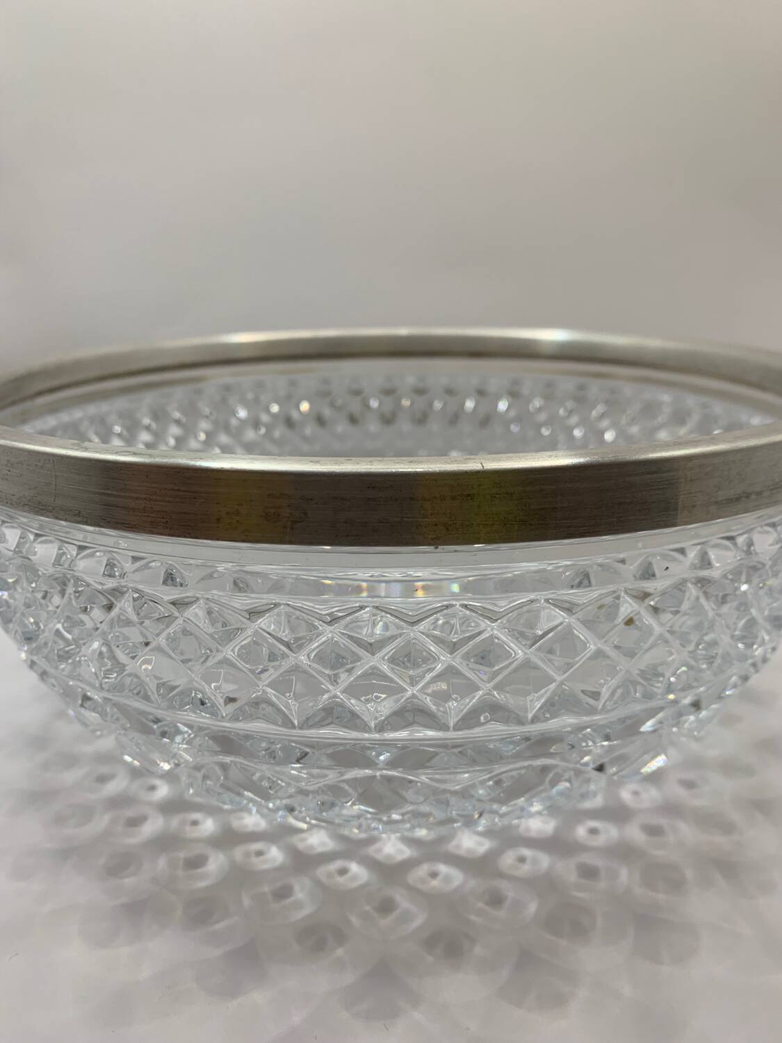 Chiseled glass (crystal?) salad bowl with silver metal edge