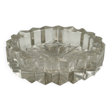 Vintage faceted pressed glass ashtray with a sun base.
