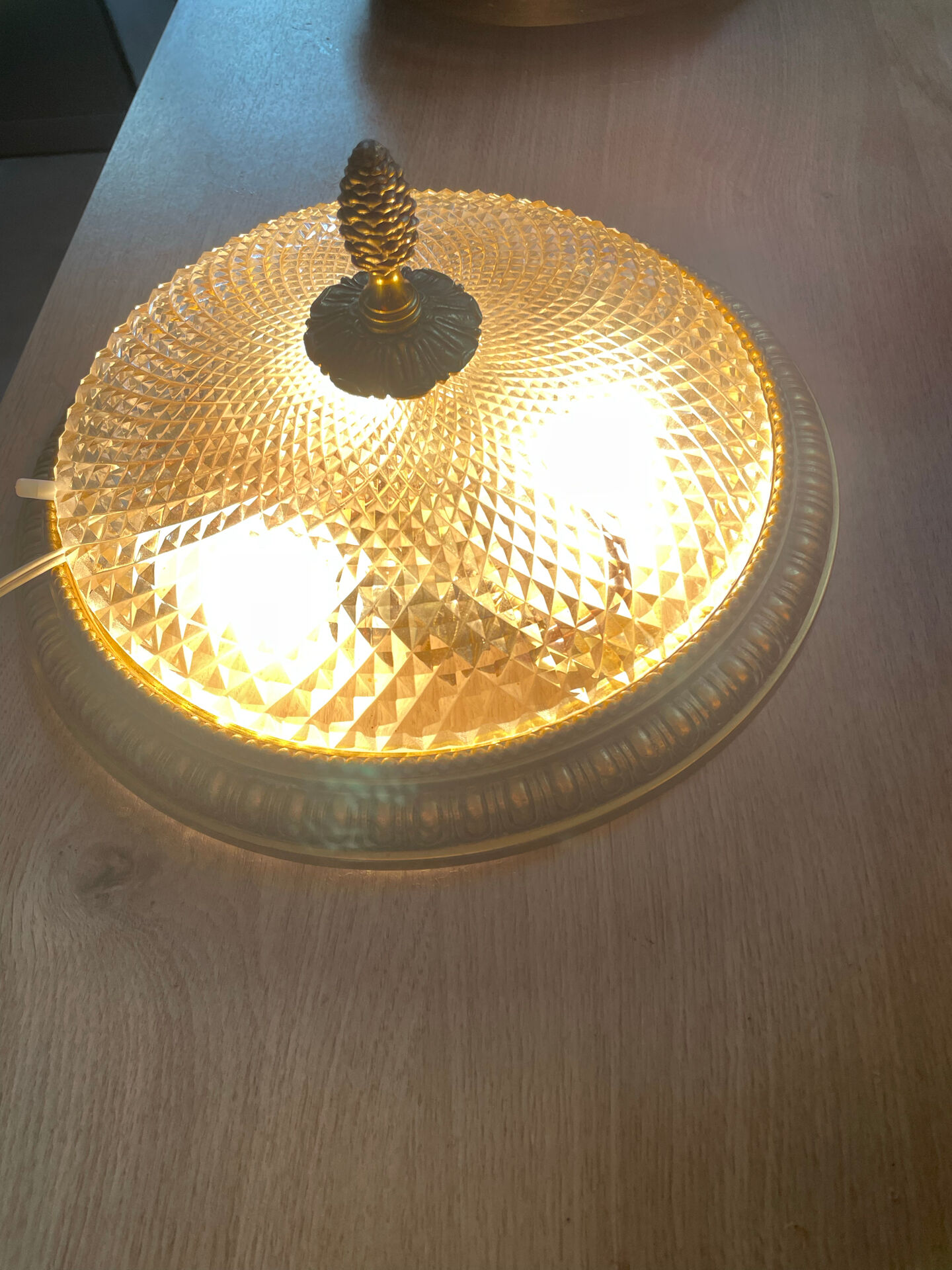 Antique ceiling light in bronze and cut crystal with diamond points.