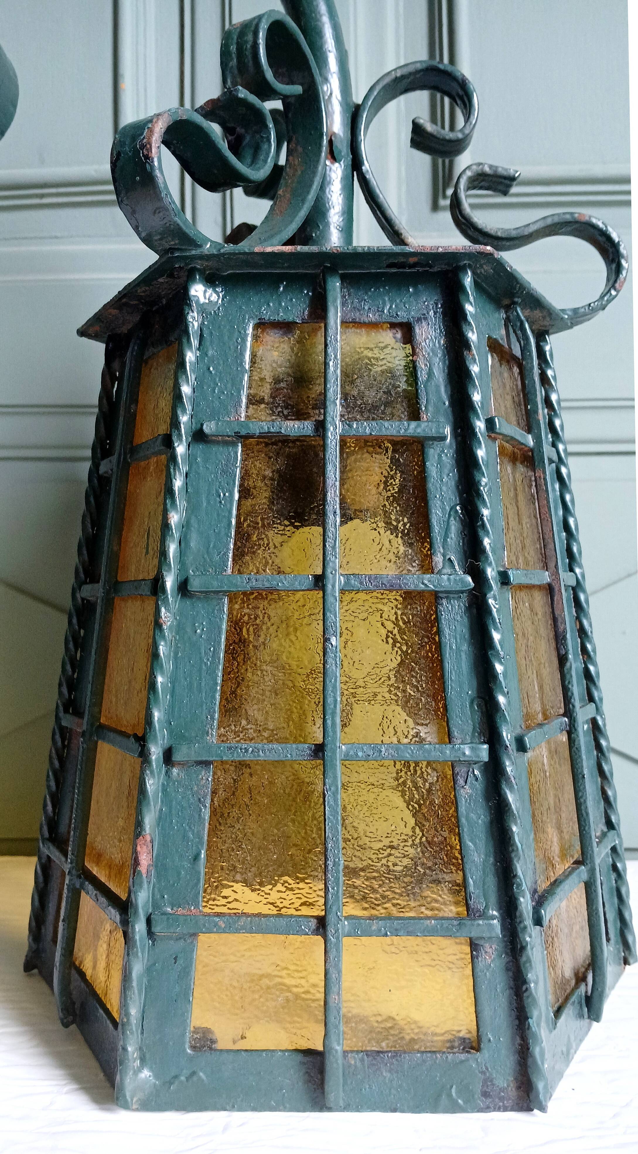Wrought iron wall lantern & amber cathedral glass
