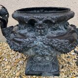 Cast iron vase decorated with mermaids.