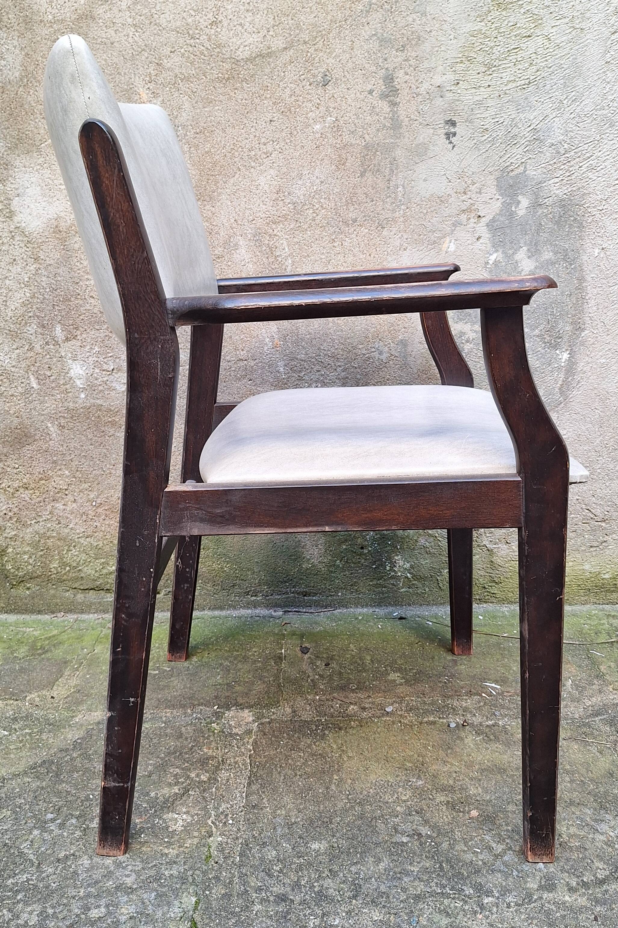 Wooden armchair and faux leather.
