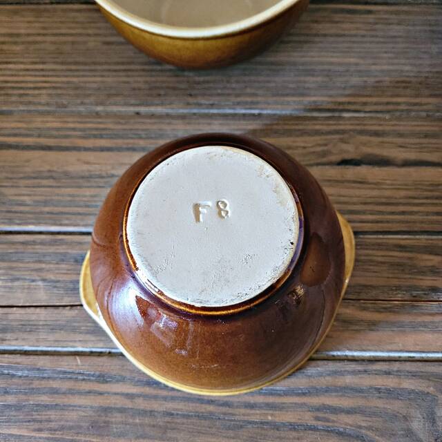 Vintage earthenware bowl with handles, brown colour.