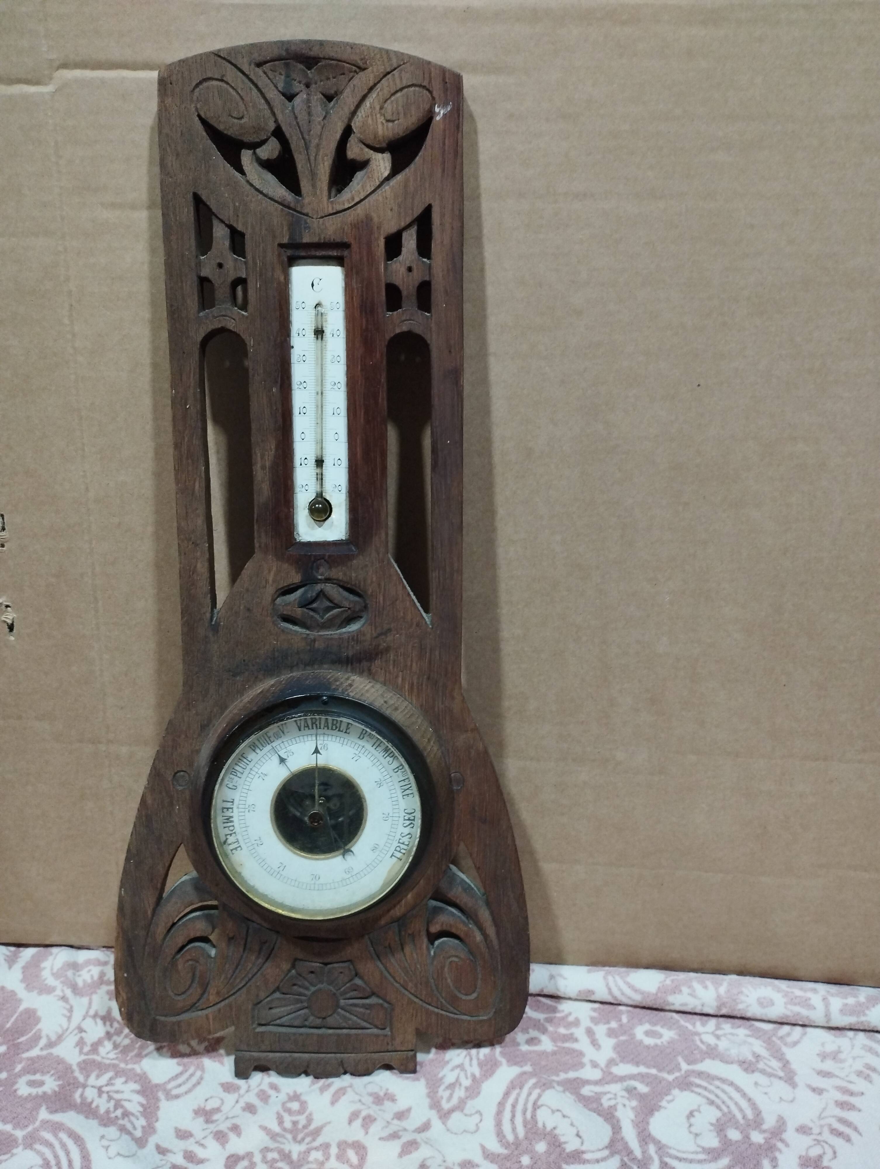 Old barometer and thermometer from the 1930s in carved wood. Signed on the back EH PARIS.