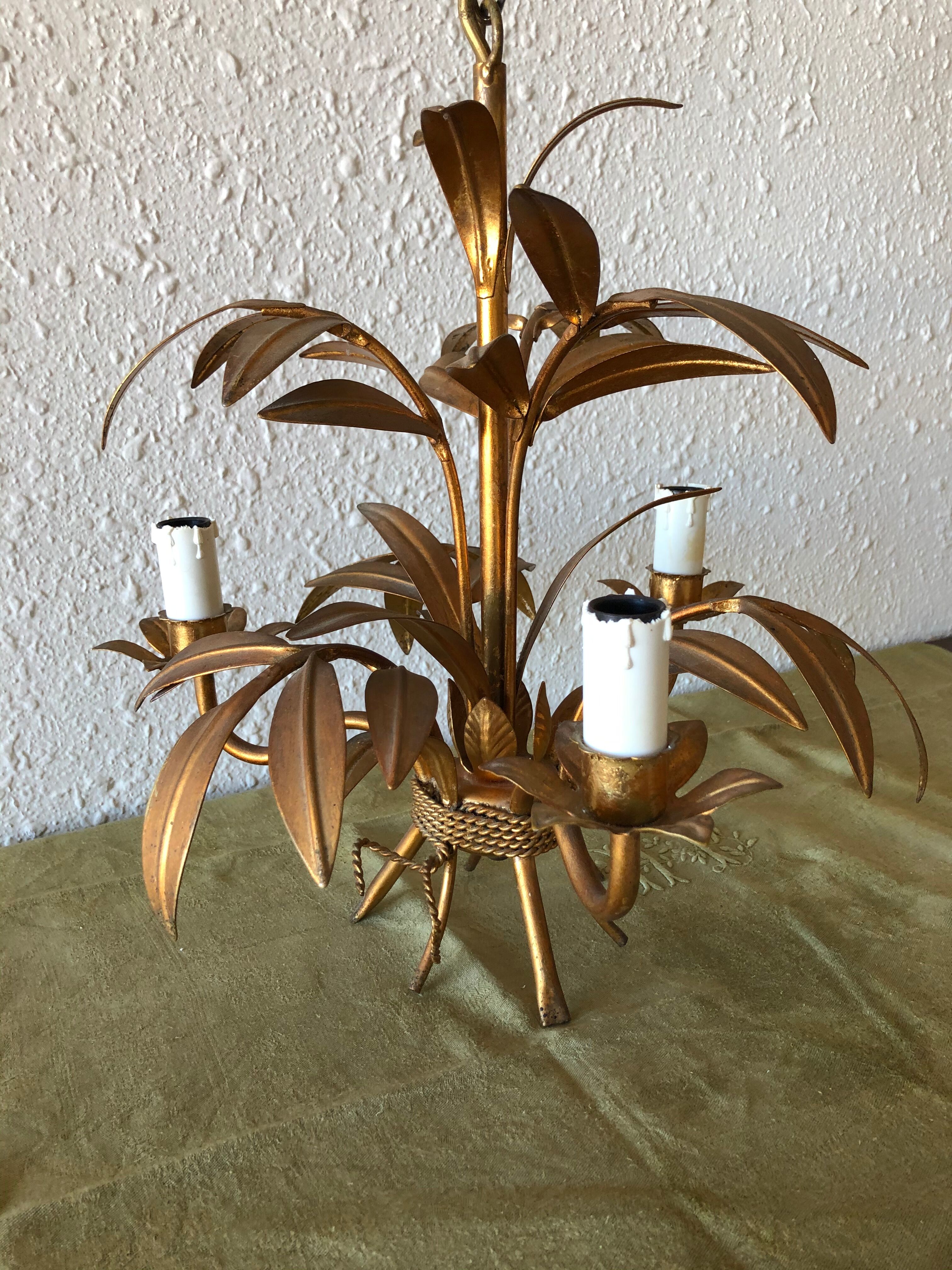 Golden vintage chandelier with leaf decoration