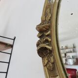 Oval wall mirror, golden floral pattern in stucco and wood, late 19th century