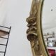 Oval wall mirror, golden floral pattern in stucco and wood, late 19th century