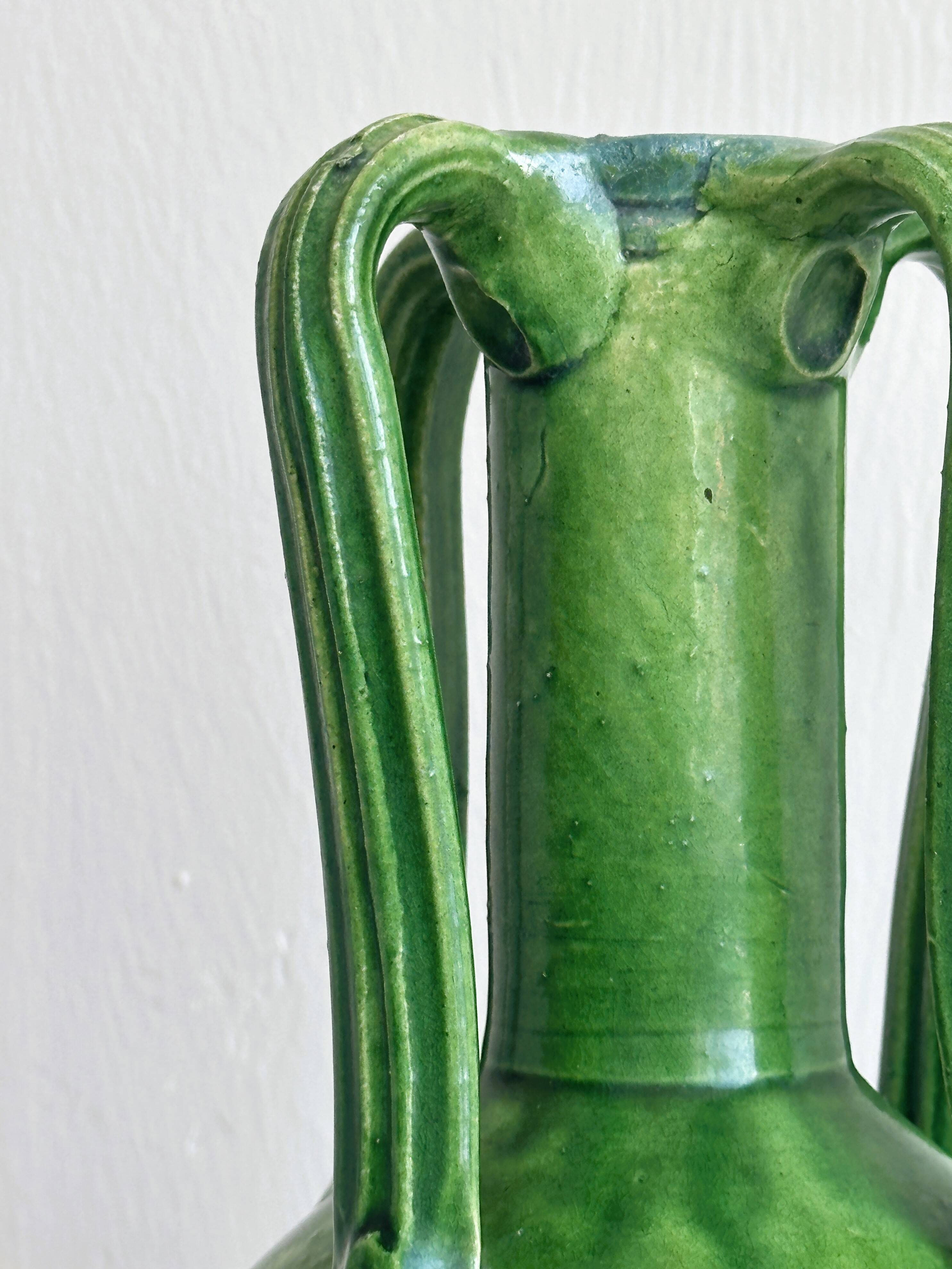 Pottery green ceramic vase with four handles.
