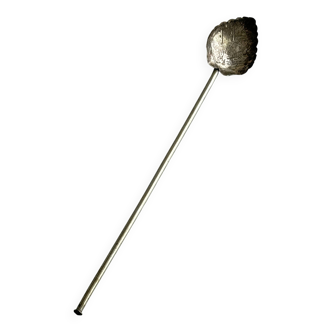 Vintage spoon in old metal, leaf pattern