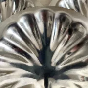 Set of 12 stainless steel scallop shells, 1970s-80s.