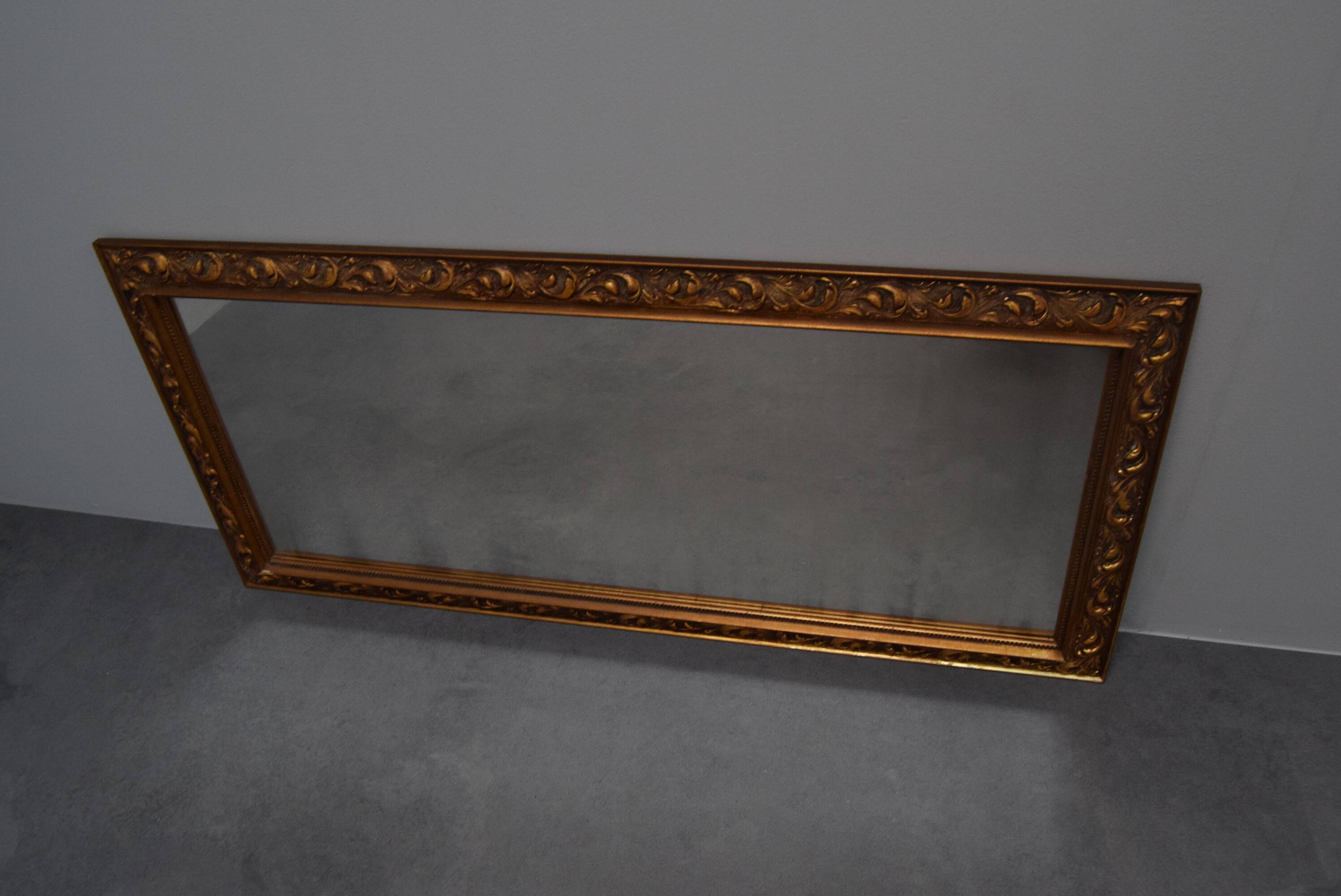 wall mirror in a decorative wooden frame.