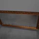 wall mirror in a decorative wooden frame.