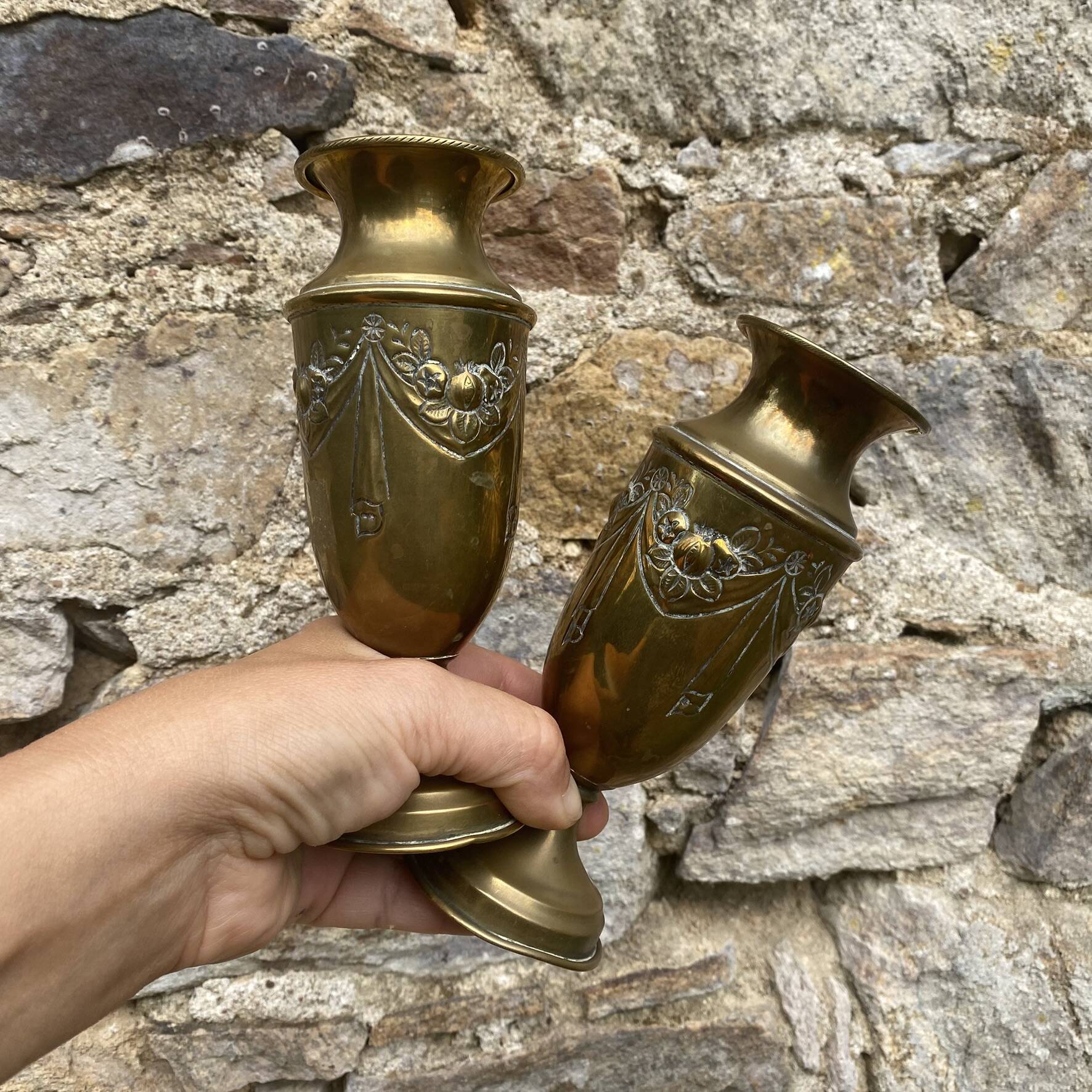 Pair of embossed brass bud vases stamped 17 cm