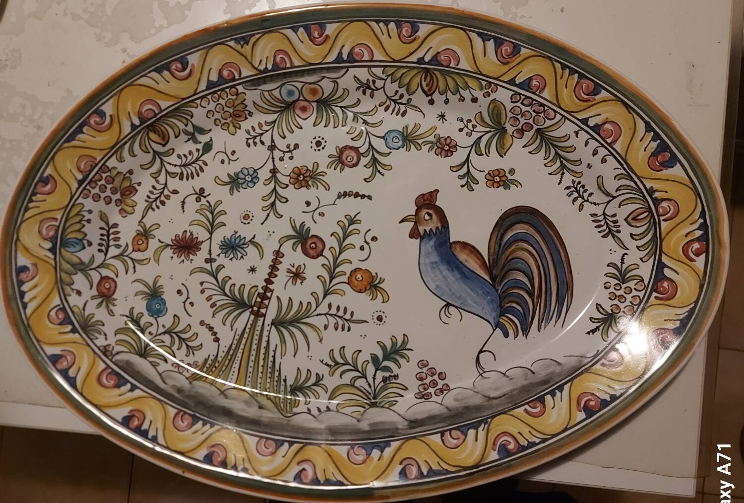 Hand-painted oval plate, numbered and signed.