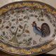 Hand-painted oval plate, numbered and signed.