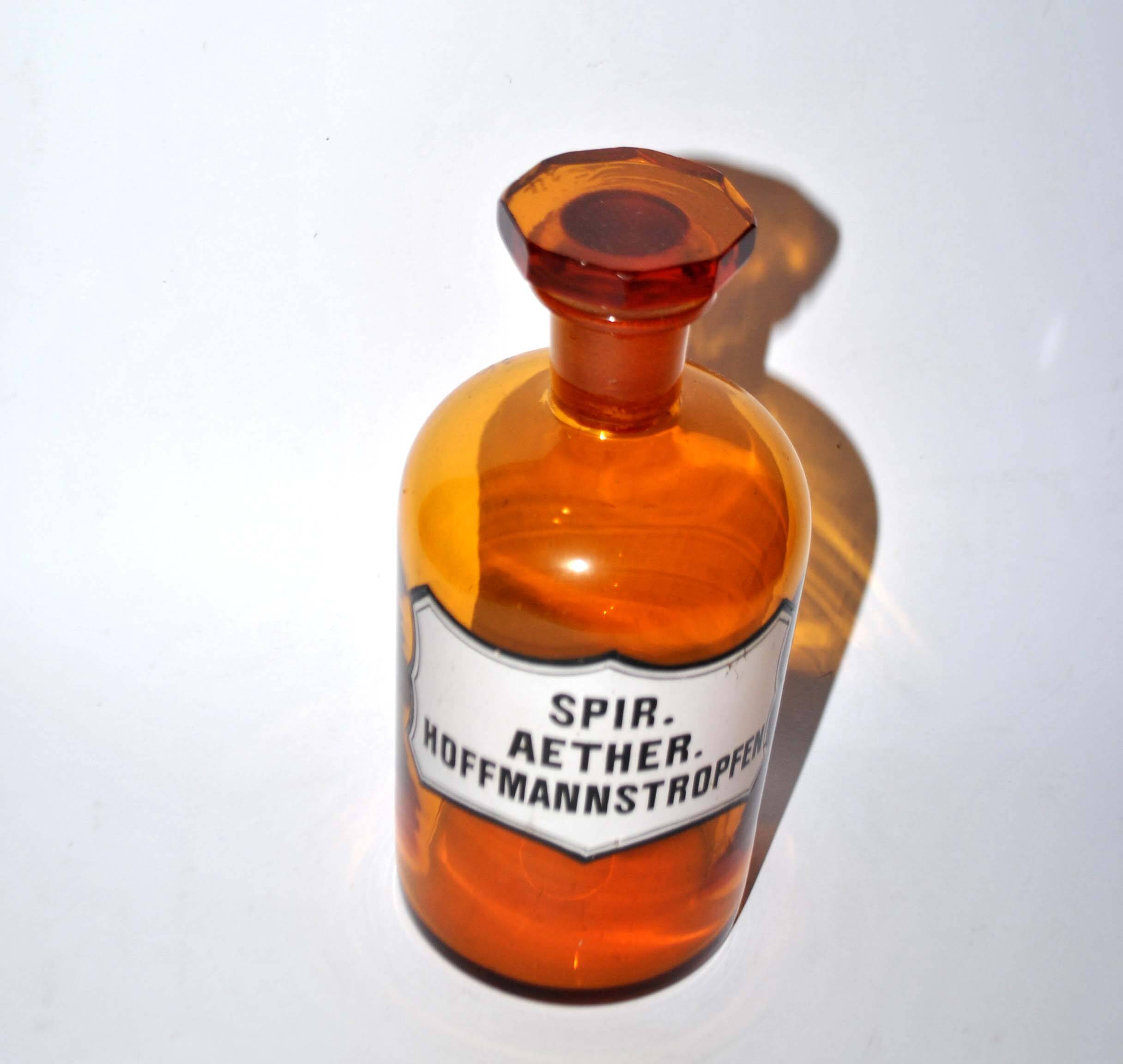 Old apothecary bottle Glass pharmacy bottle with enameled label