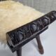Carved wooden stool covered with Celtic-style sheepskin
