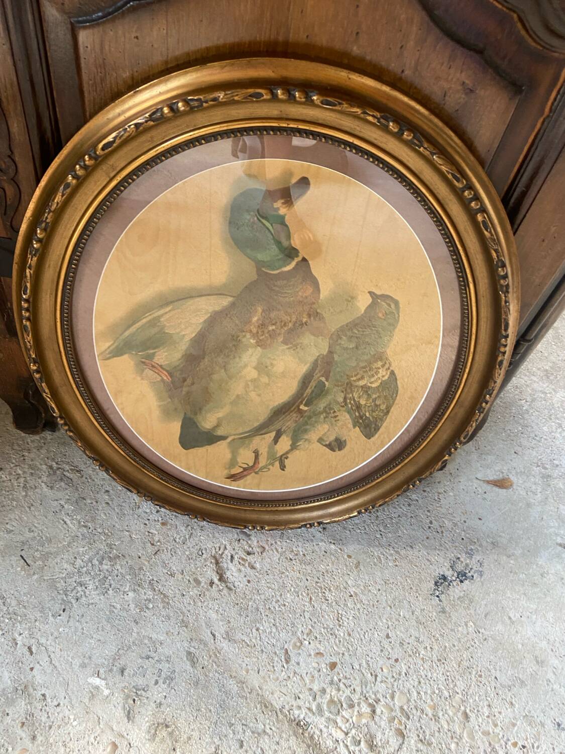 Antique oval frame with an oil painting of green collars