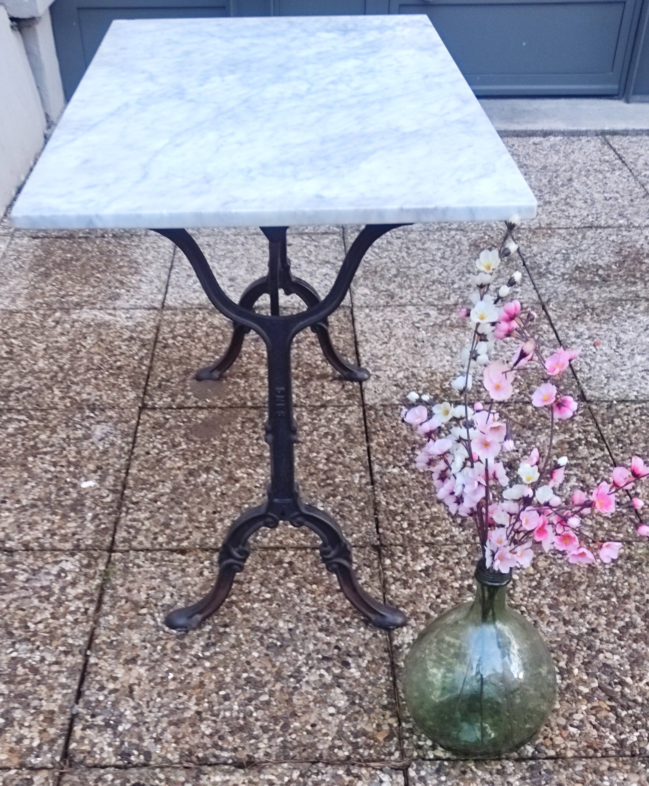 White marble table, cast iron base signed SNES, made in France