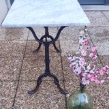 White marble table, cast iron base signed SNES, made in France