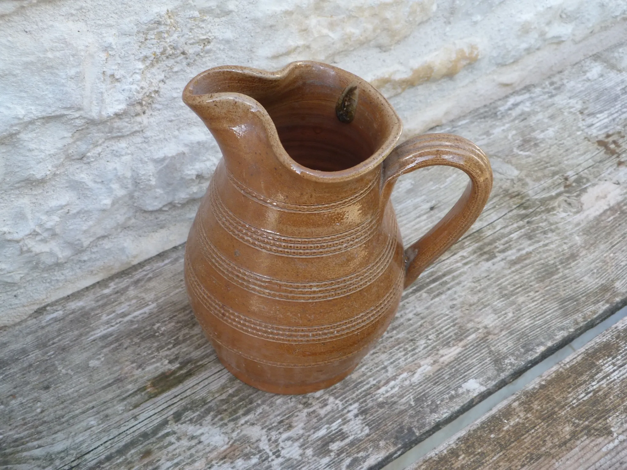 Old stoneware wine jug with patterns