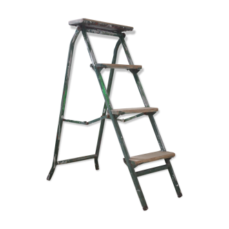 Wooden stepladder and green metal