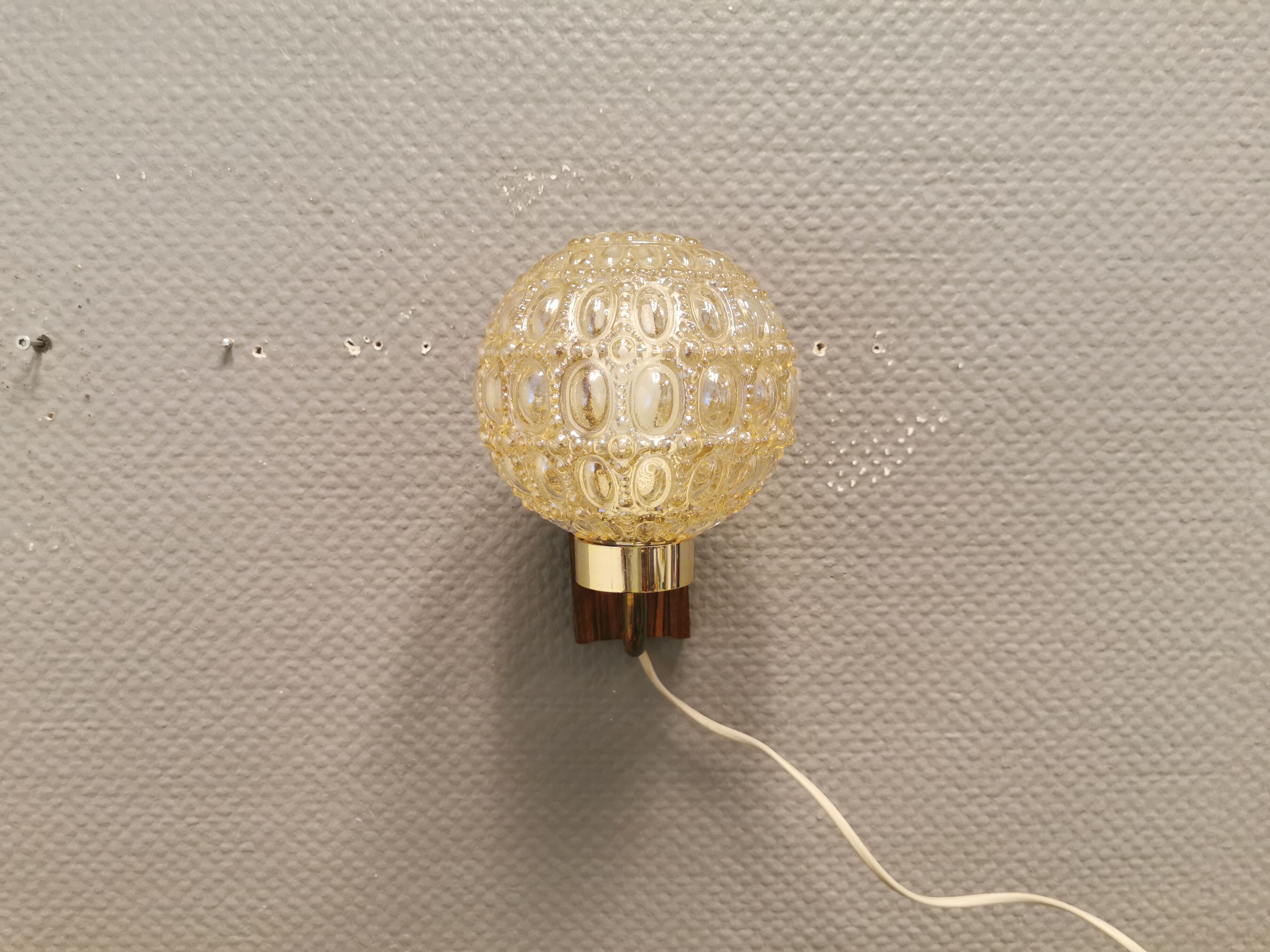 Wall light in rosewood with bobble glass ball shade.