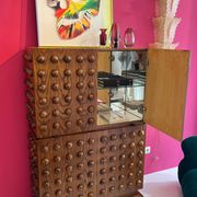 Italian brutalist-style bar made of wood and glass, drinks cabinet.