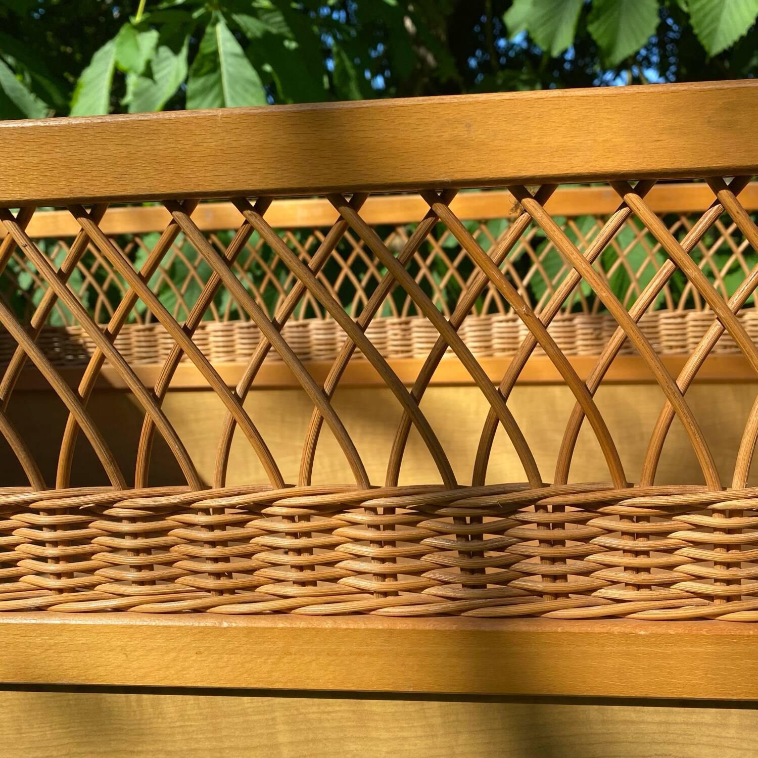 Vintage wooden and rattan baby cot from the 1960s.