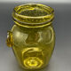 Yellow bubbled glass apothecary jar with cork lid.