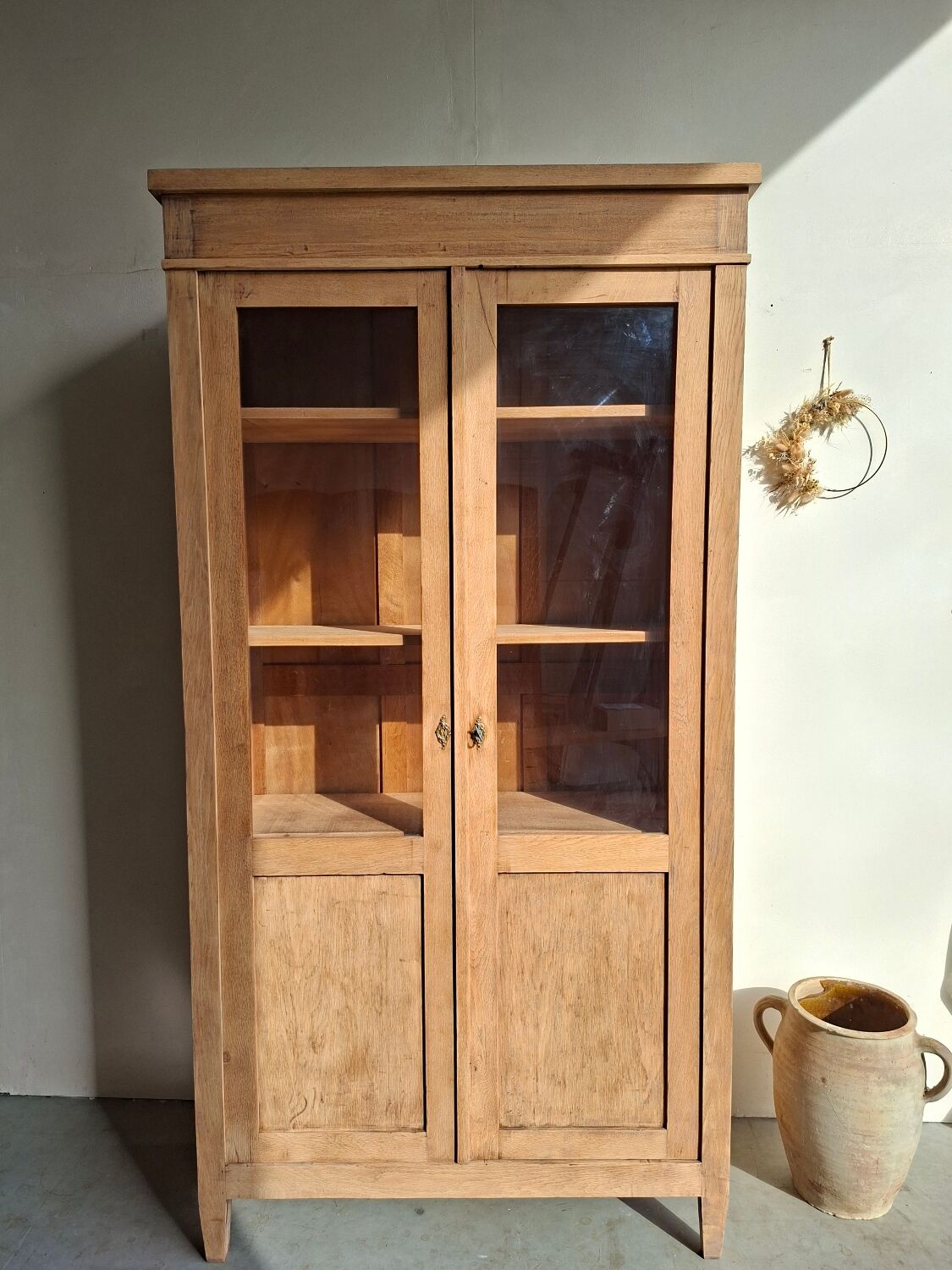 Large antique display cabinet in patinated solid oak.