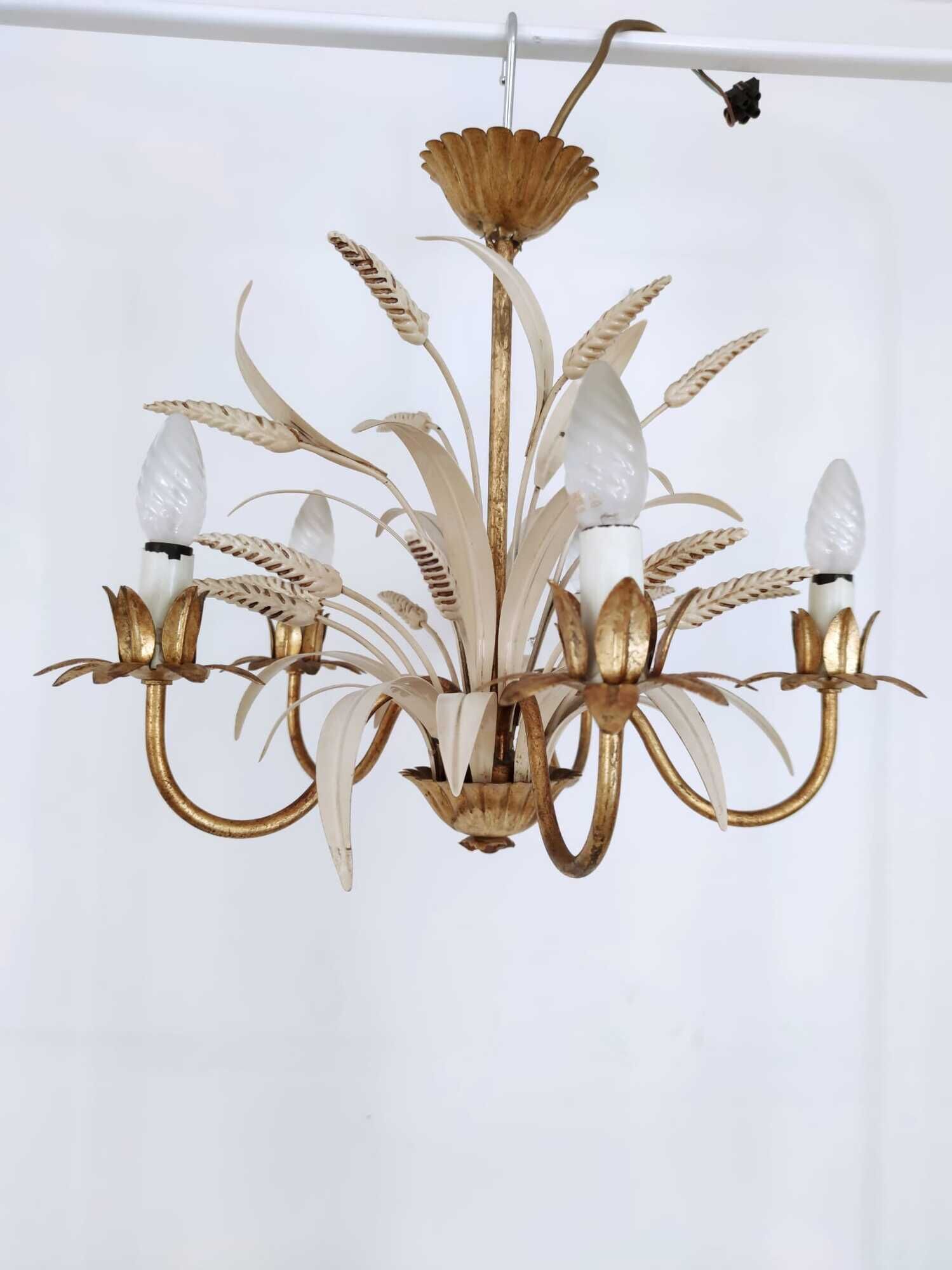 Vintage wrought iron chandelier decorated with golden and beige reeds