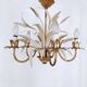 Vintage wrought iron chandelier decorated with golden and beige reeds