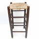 Blackened wooden bar top stool with mulched seat