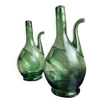 Pair of blown glass wine decanters in blue/green hues.