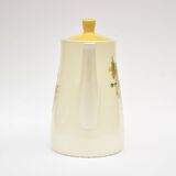 Old glazed ceramic coffee pot decorated with sunflowers