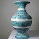 Vintage turquoise ceramic baluster vase with incised decoration.
