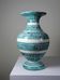 Vintage turquoise ceramic baluster vase with incised decoration.