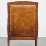 Sheepskin and wooden vintage Art Deco design armchair in a cognac color