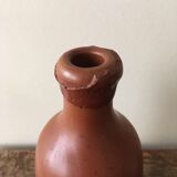 Old bottle in hazelnut Brown sandstone with label